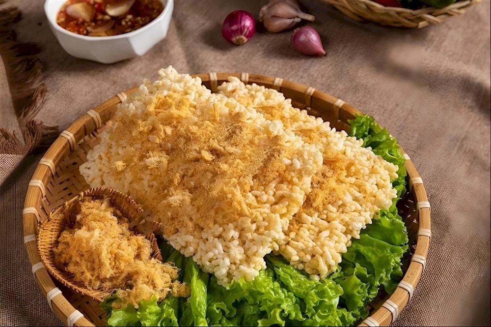 Crispy rice served with savory goat sauce is a signature dish that no visitor should miss
